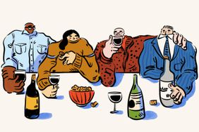 Four people drinking wine and having some snacks