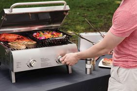 Man grilling on Cuisinart CGG-306 Chef's Style Portable Propane Tabletop