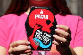 A teen holds a package of the One Chip Challenge from Paqui
