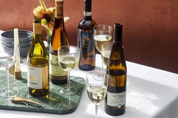 Various white wine bottles and glasses