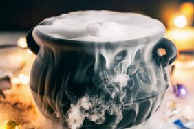 A Halloween punch in a decorative cauldron with dry ice